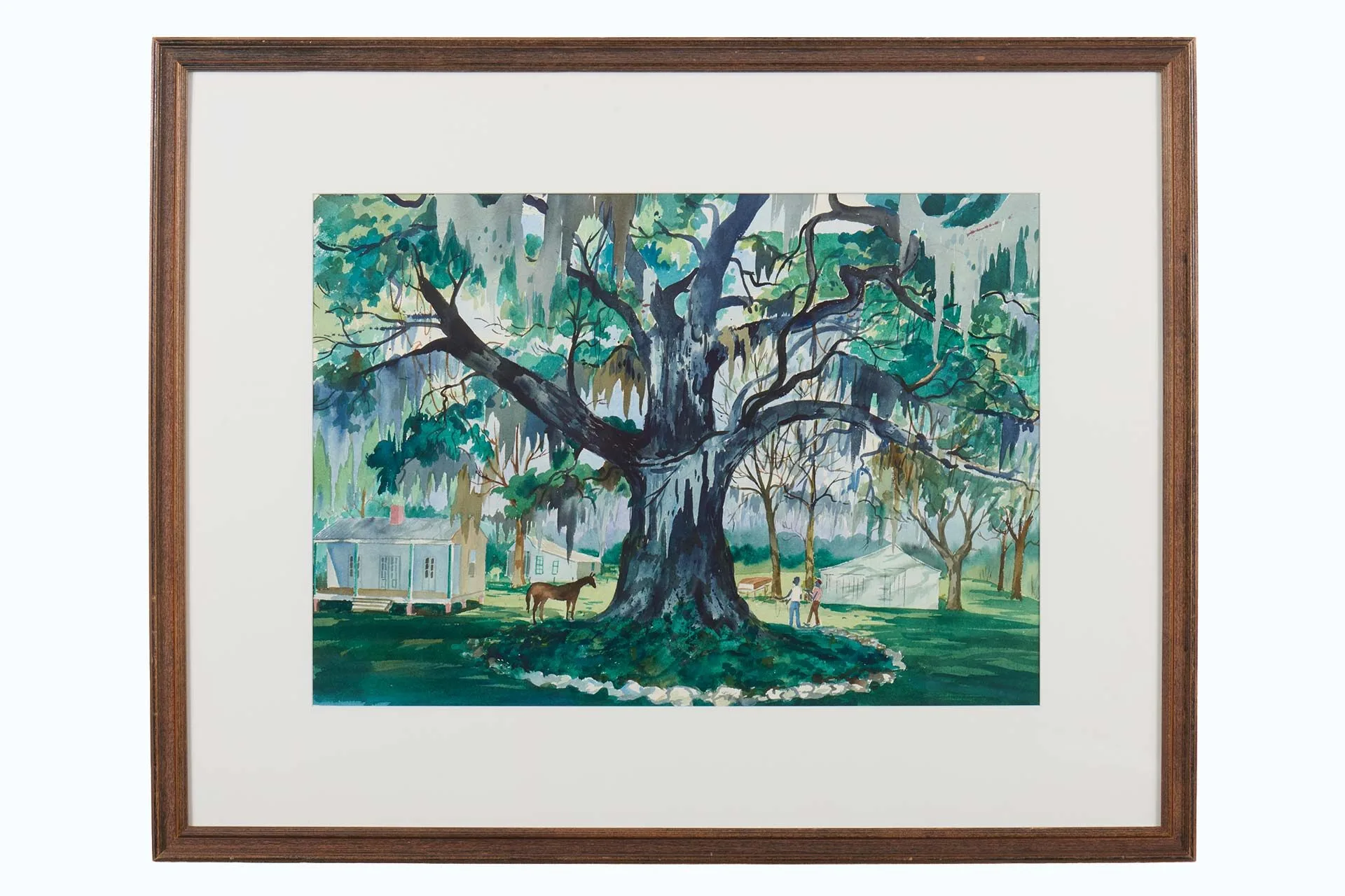 Framed painting of a large tree with hanging moss, surrounded by grass, houses, and people. This peaceful, vibrant scene in shades of green and blue reflects the charm celebrated at local art Lafayette and Lafayette art museum exhibits.