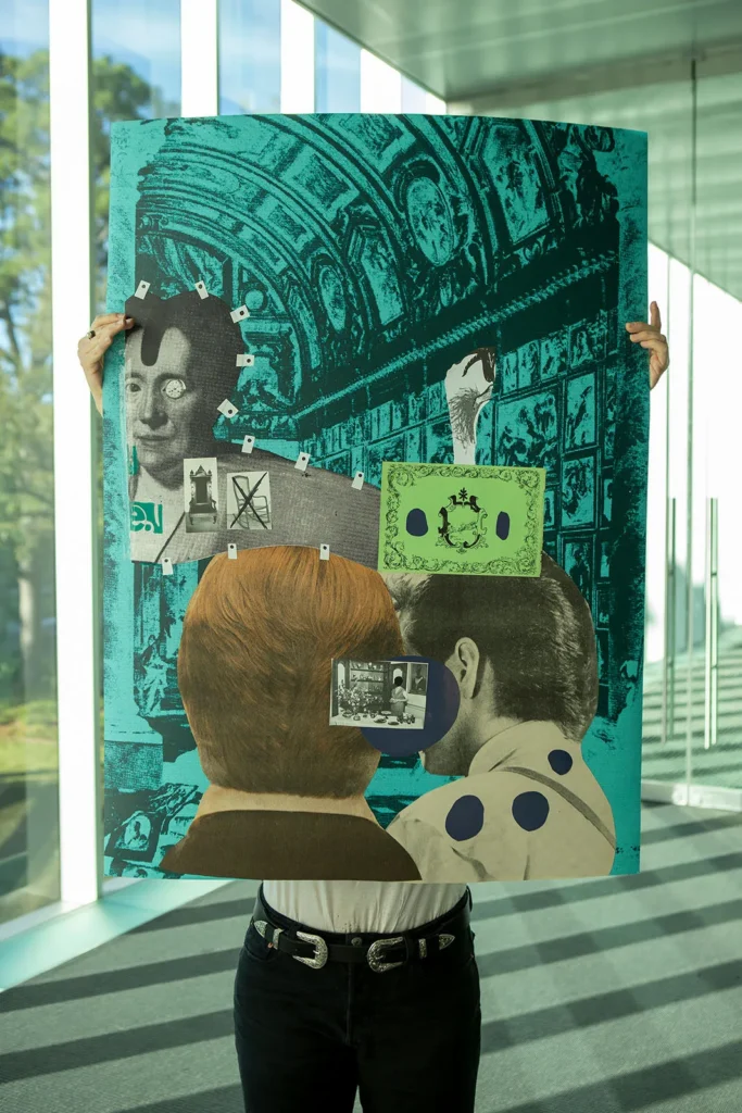 A person holds up a large collage artwork featuring retro photos, abstract shapes, and bold colors in front of a modern windowed background with natural light. The persons face is hidden behind the artwork.
