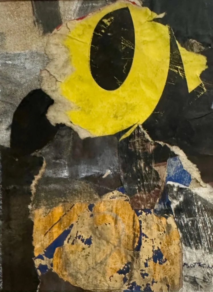 An abstract collage featuring torn layers of paper in yellow, black, and ochre tones, creating a textured composition with a large, bold yellow oval shape as the central focus.