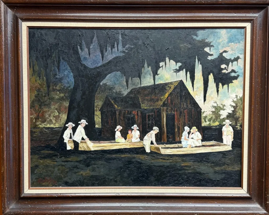 Framed painting of people in white clothing and hats sitting in two wooden boats near a rustic cabin and large tree draped with moss, set in a dark, swampy landscape under a cloudy sky.