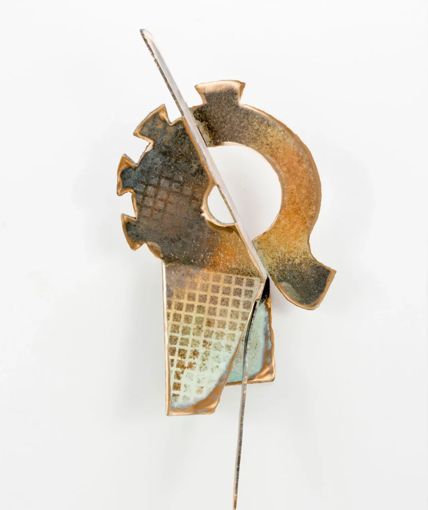Abstract metal sculpture with geometric shapes, a circular form with gear-like edges, intersected by a diagonal rod, featuring textured and rusted surfaces reminiscent of Elemore Morgan Jr.’s expressive style. Set against a plain white background.